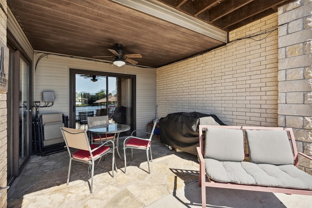 view of patio with area for grilling, outdoor lounge area, a ceiling fan, and outdoor dining space