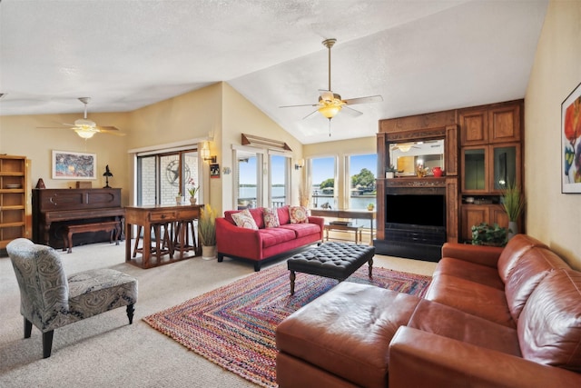 living room featuring ceiling fan, light colored carpet, and lofted ceiling