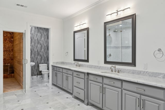 full bathroom with double vanity, a sink, toilet, and ornamental molding