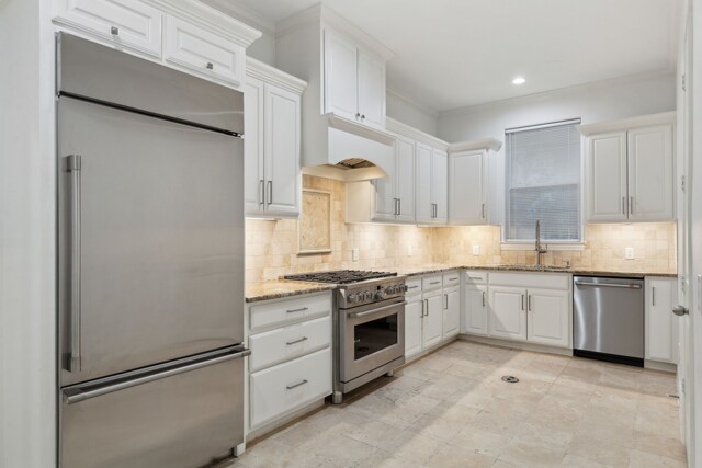 5309 Settlement Way, Mckinney, TX 75070 - kitchen featuring premium appliances, a sink, white cabinetry, light stone countertops, and recessed lighting