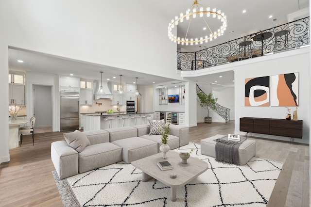 5309 Settlement Way, Mckinney, TX 75070 - living room with a high ceiling, a chandelier, light wood-style floors, recessed lighting, and baseboards