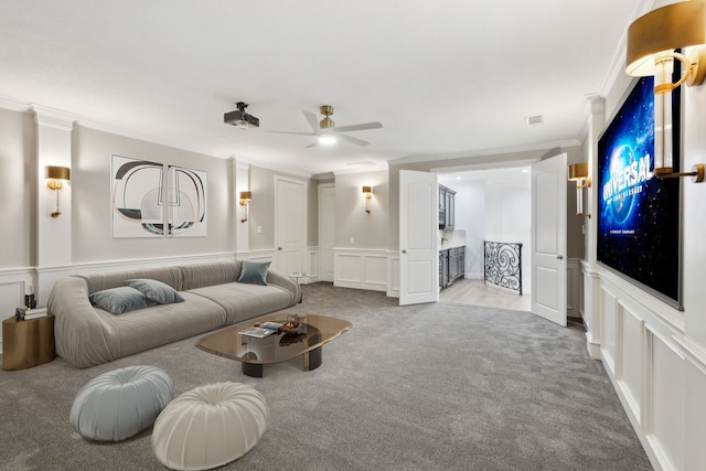 5309 Settlement Way, Mckinney, TX 75070 - living room with a decorative wall, carpet, ornamental molding, ceiling fan, and a wainscoted wall