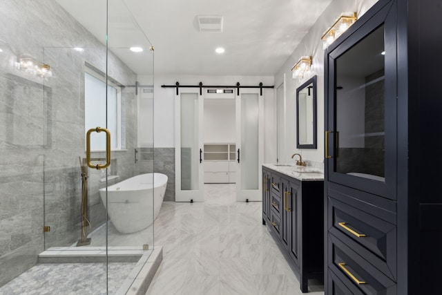 full bath featuring vanity, a soaking tub, a stall shower, and marble finish floor