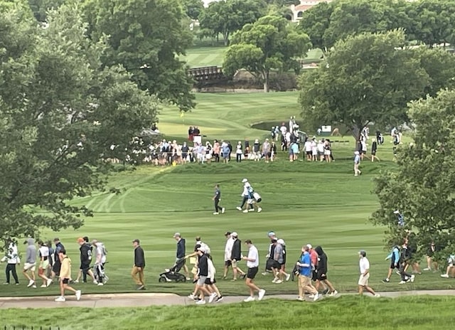 view of home's community with golf course view and a yard