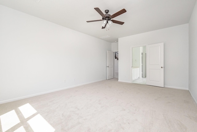 interior space featuring a ceiling fan, baseboards, light colored carpet, and visible vents