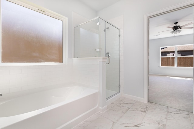 bathroom featuring ceiling fan, marble finish floor, baseboards, a shower stall, and a bath