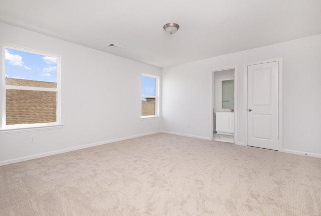 carpeted empty room with baseboards and visible vents