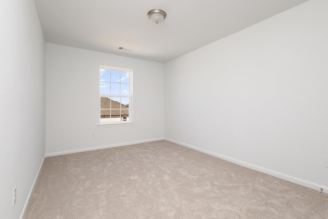 unfurnished room featuring carpet flooring, baseboards, and visible vents