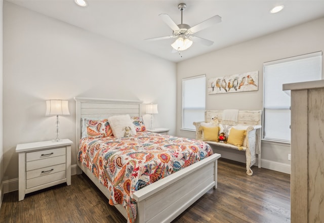 bedroom with dark wood-style flooring, multiple windows, recessed lighting, and baseboards