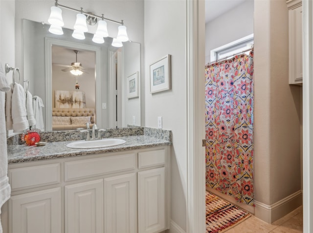 full bath featuring vanity, a shower with curtain, ceiling fan, and baseboards