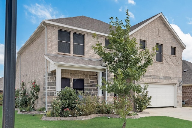view of front of house featuring roof with shingles, a front lawn, brick siding, a garage, and driveway