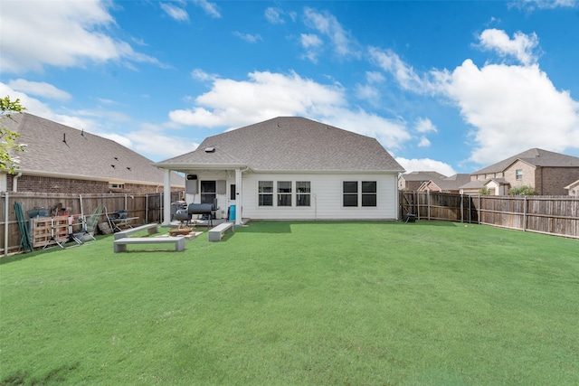 back of property featuring a lawn, a fenced backyard, and a patio area