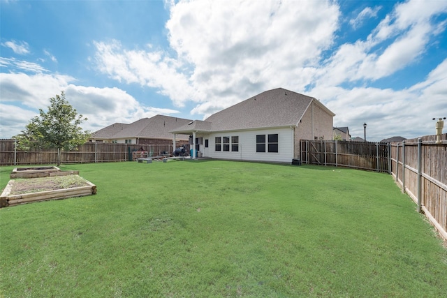 view of yard featuring a fenced backyard and a vegetable garden