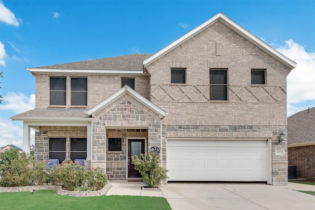 view of front of home with an attached garage, a shingled roof, stone siding, and concrete driveway