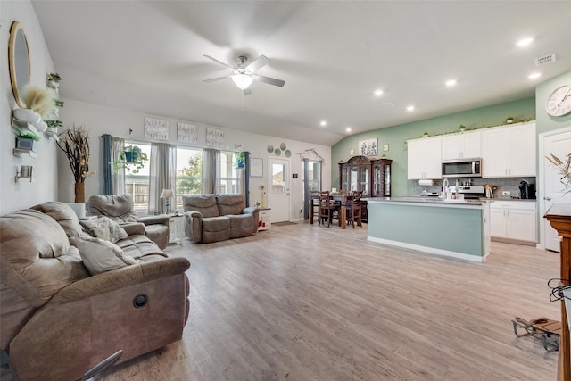 living area with recessed lighting, ceiling fan, light wood-type flooring, and visible vents
