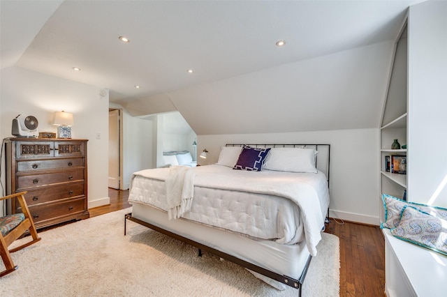 bedroom featuring baseboards, vaulted ceiling, recessed lighting, and wood finished floors