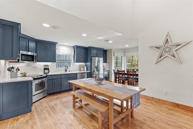 kitchen with light countertops, appliances with stainless steel finishes, and plenty of natural light