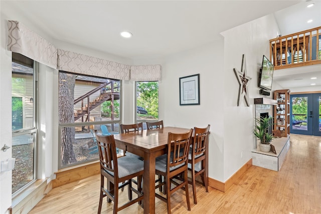 dining space featuring baseboards, recessed lighting, wood finished floors, and stairway