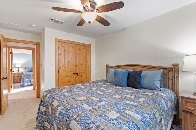 bedroom with a closet, a ceiling fan, carpet flooring, and visible vents