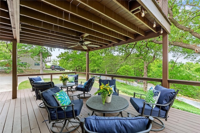 wooden terrace with ceiling fan and outdoor lounge area
