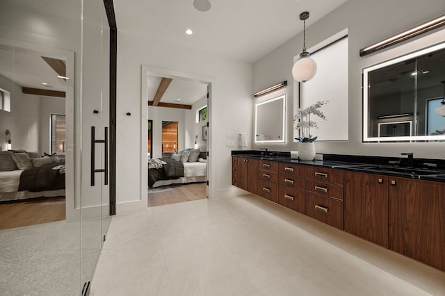 full bathroom featuring double vanity, a sink, and connected bathroom