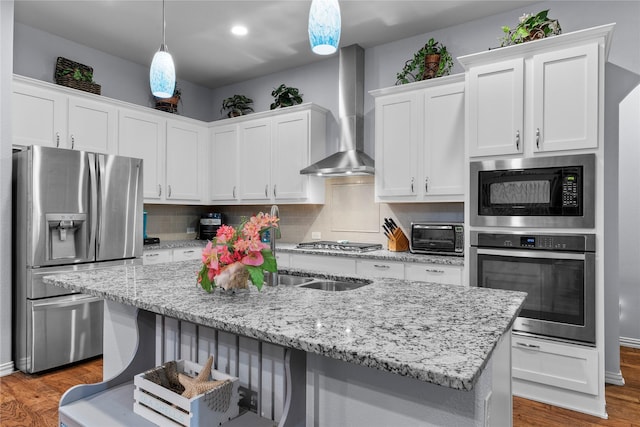 1521 Vintage Ln, Wylie, TX 75098 - kitchen with appliances with stainless steel finishes, wood finished floors, white cabinetry, tasteful backsplash, and recessed lighting