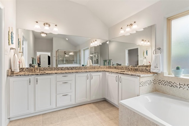 bathroom featuring double vanity, a stall shower, a sink, and lofted ceiling