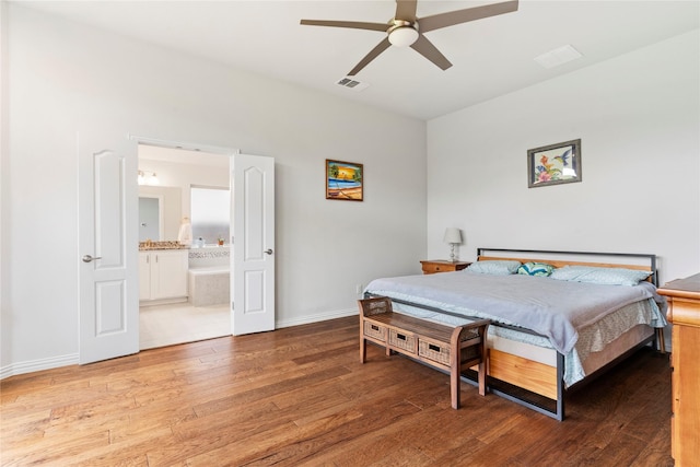 1521 Vintage Ln, Wylie, TX 75098 - bedroom featuring wood finished floors, baseboards, connected bathroom, and ceiling fan