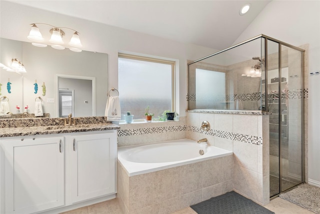 bathroom with vaulted ceiling, vanity, a stall shower, and a bath