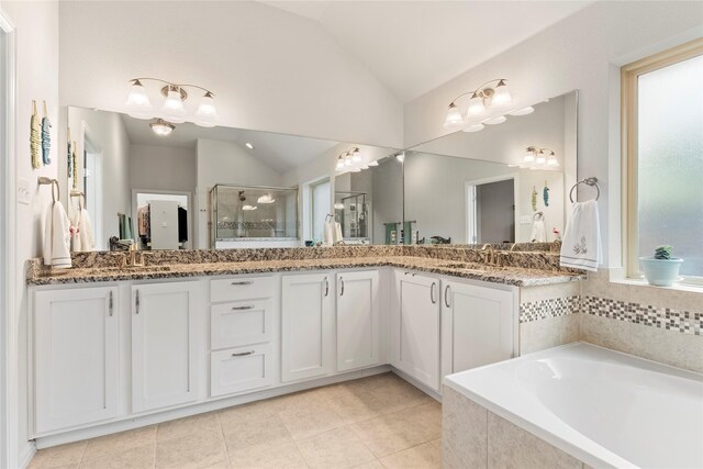 1521 Vintage Ln, Wylie, TX 75098 - bathroom with vaulted ceiling, a shower stall, double vanity, tile patterned floors, and a garden tub