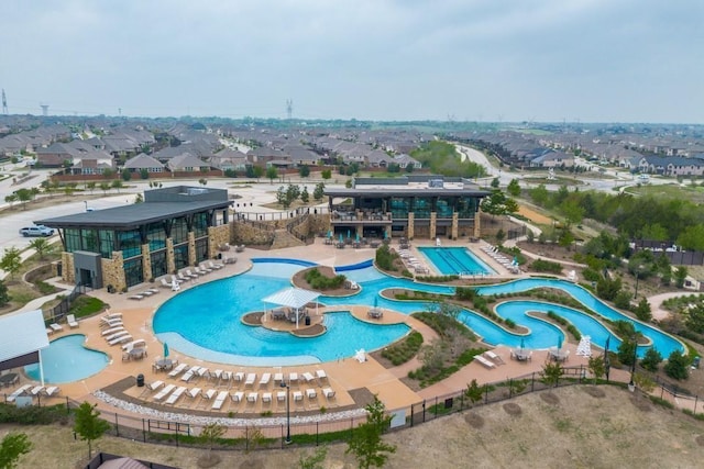 view of swimming pool with a residential view and a water slide