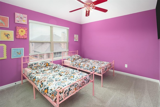 carpeted bedroom featuring baseboards and ceiling fan