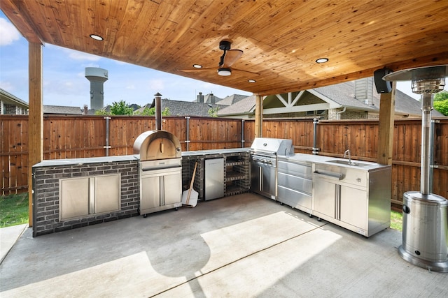 view of patio / terrace featuring a fenced backyard, a sink, and area for grilling