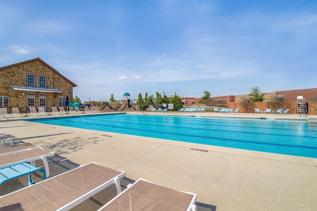 community pool with a patio area