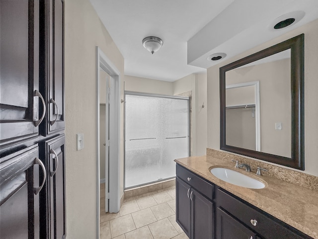 bathroom with vanity, tile patterned floors, and a stall shower