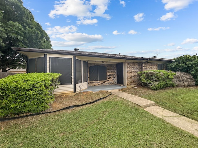 view of front of house with a front lawn and brick siding