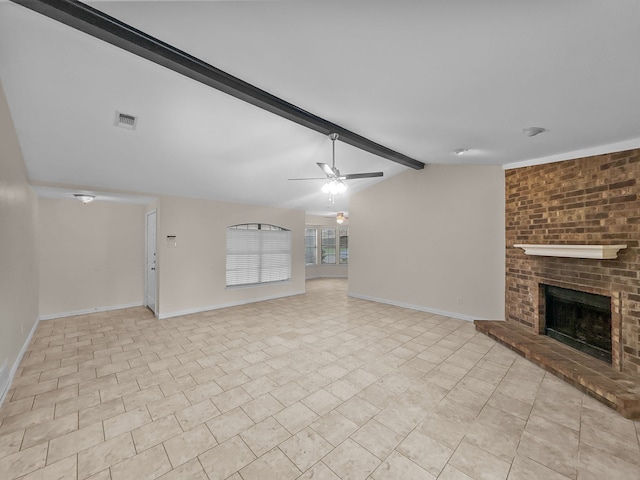 unfurnished living room with baseboards, vaulted ceiling with beams, a brick fireplace, and visible vents