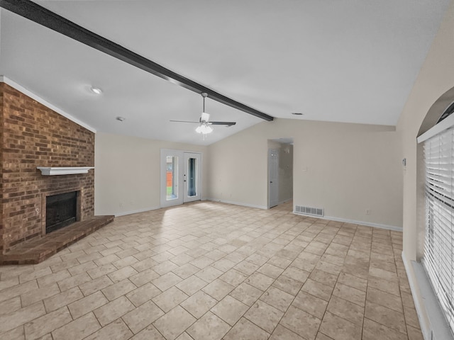 unfurnished living room featuring ceiling fan, visible vents, a brick fireplace, baseboards, and lofted ceiling with beams
