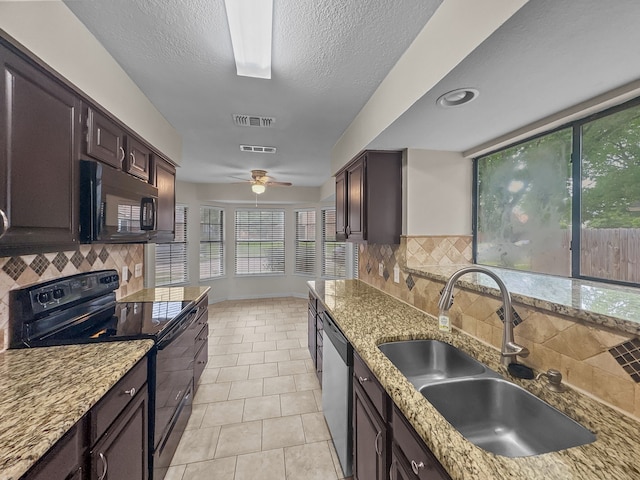 kitchen featuring a sink, decorative backsplash, black appliances, and visible vents