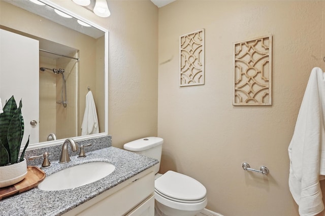 full bathroom featuring vanity, walk in shower, and toilet