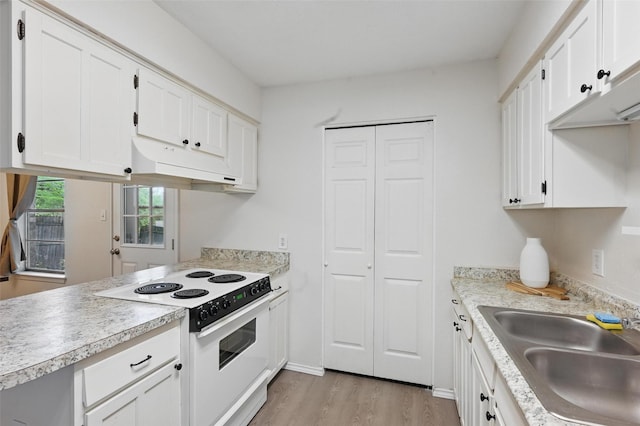 kitchen with white electric range oven, a sink, light wood-style floors, white cabinetry, and under cabinet range hood