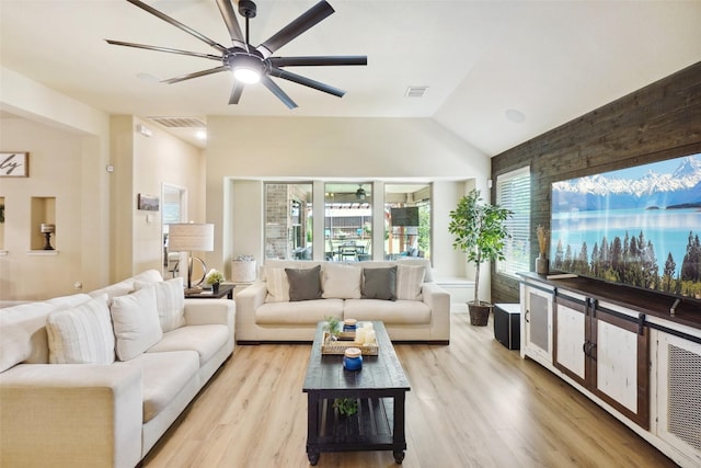 living room with visible vents, light wood finished floors, ceiling fan, and lofted ceiling