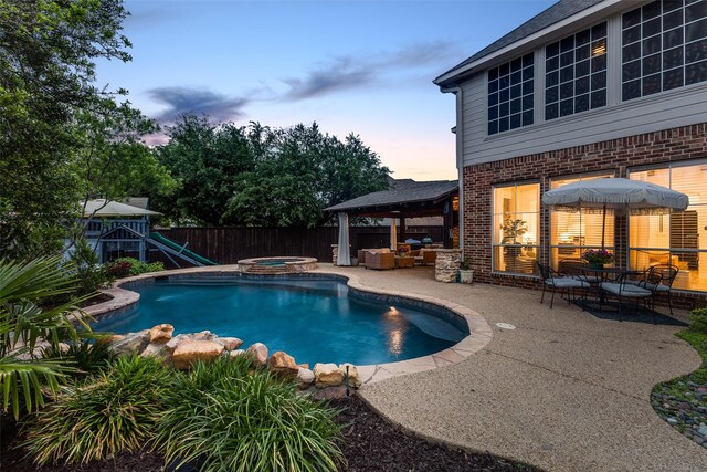 view of pool featuring a gazebo, a pool with connected hot tub, a fenced backyard, an outdoor living space, and a patio area