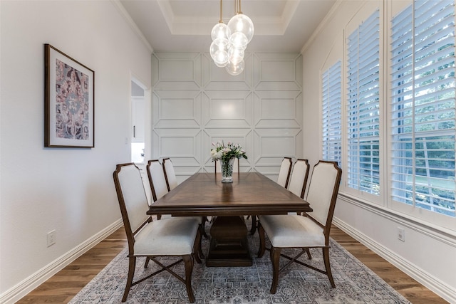 unfurnished office featuring crown molding, baseboards, built in study area, and light wood-style floors