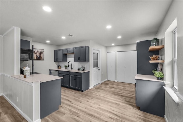 1013 Springdale Rd, Bedford, TX 76021 - kitchen featuring a sink, light countertops, light wood-style flooring, recessed lighting, and stainless steel dishwasher