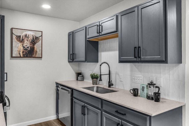 1013 Springdale Rd, Bedford, TX 76021 - kitchen featuring stainless steel dishwasher, baseboards, light countertops, tasteful backsplash, and a sink