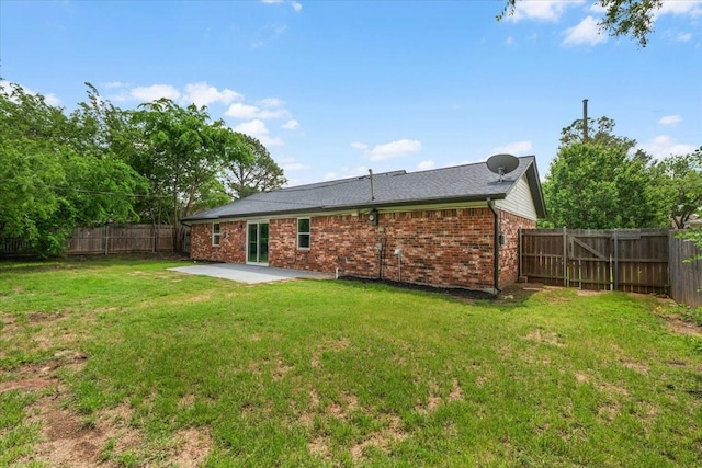 1013 Springdale Rd, Bedford, TX 76021 - back of property with a fenced backyard, a patio, a yard, and brick siding
