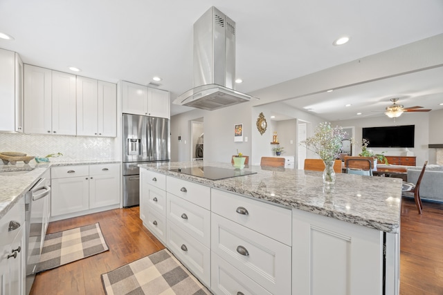 kitchen featuring island exhaust hood, ceiling fan, white cabinets, and stainless steel appliances