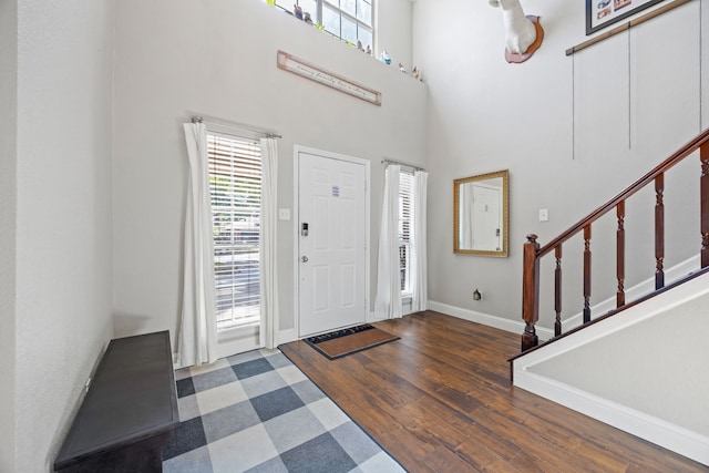 traditional home featuring a front lawn, fence, covered porch, brick siding, and driveway