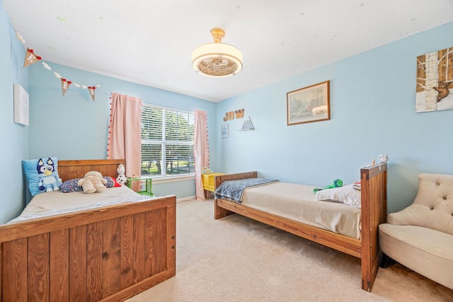 sitting room featuring carpet floors, a ceiling fan, and baseboards